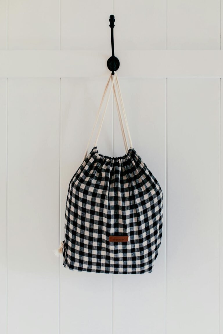 Sustainable checkered cotton bag hanging on wall, perfect for eco-conscious storage solutions.